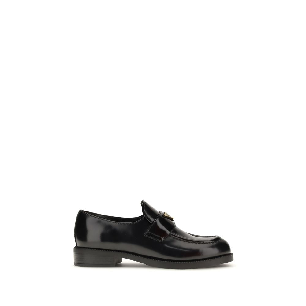 Prada Loafers Neri in Pelle Lucida Logo Triangolo Metallico SS26